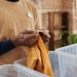 person sorting clothes by color