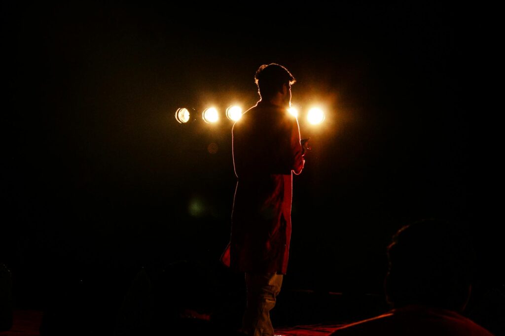 actor on stage spotlight
