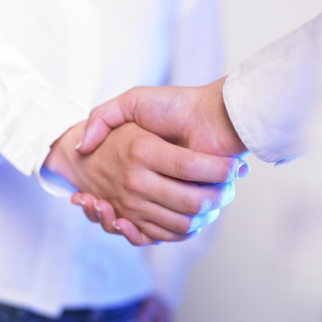 business school partnership handshake