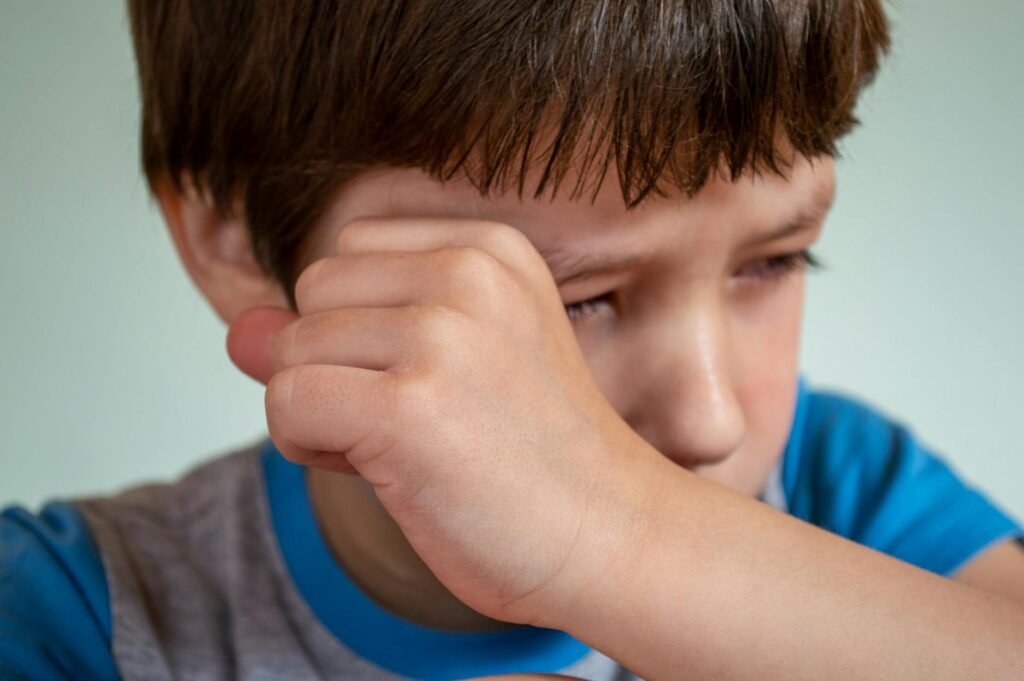 child looking sad adult hand reaching