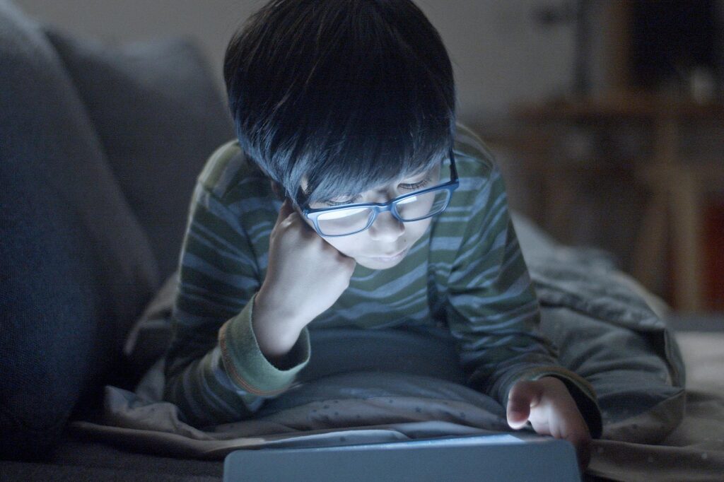 child using tablet with parent looking