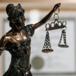 courtroom scales of justice and media symbols