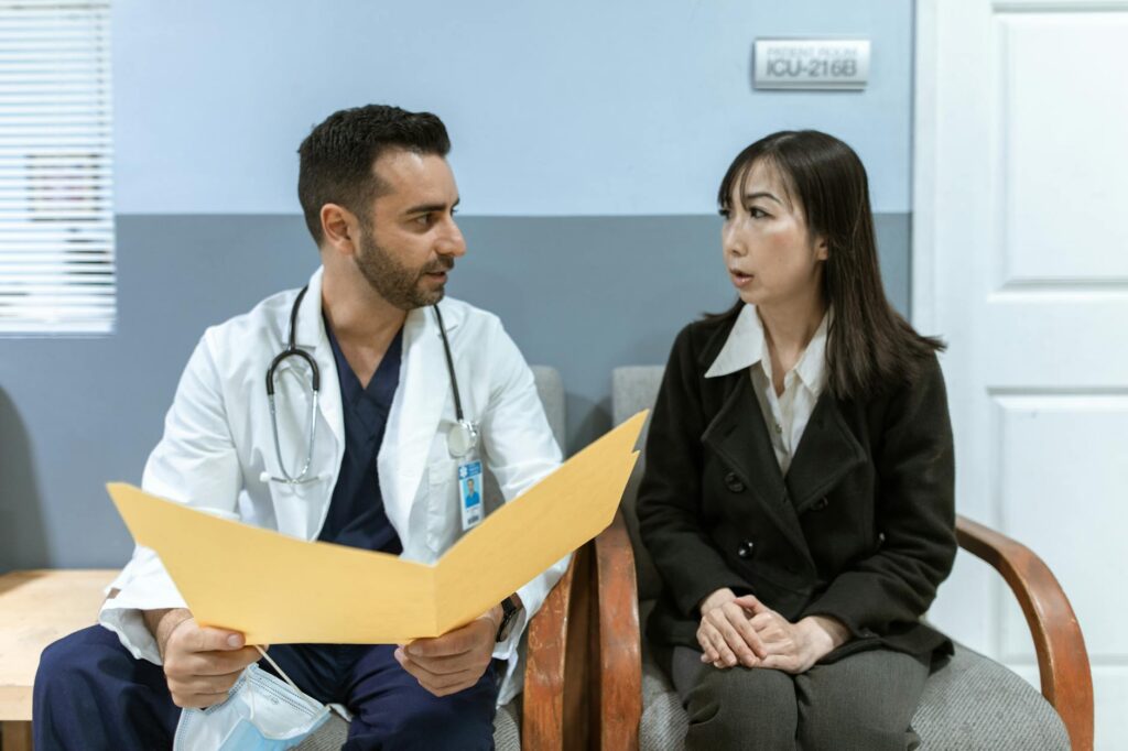 doctor and patient talking in hospital room