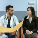 doctor and patient talking in hospital room