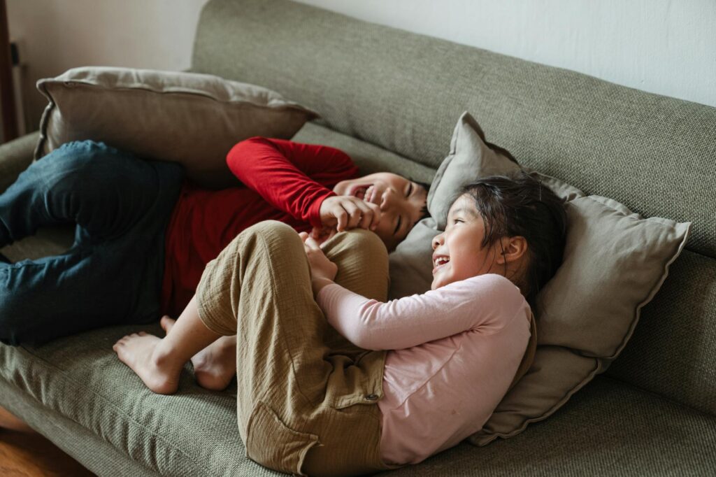 family laughing in living room lifestyle photo