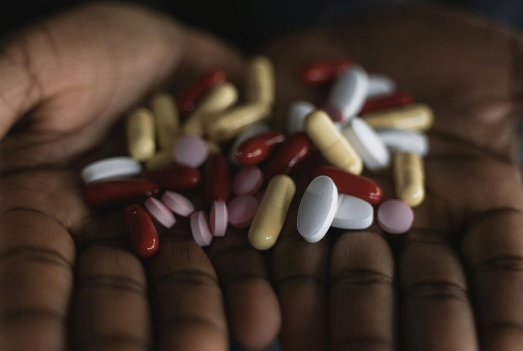 person overwhelmed by pills