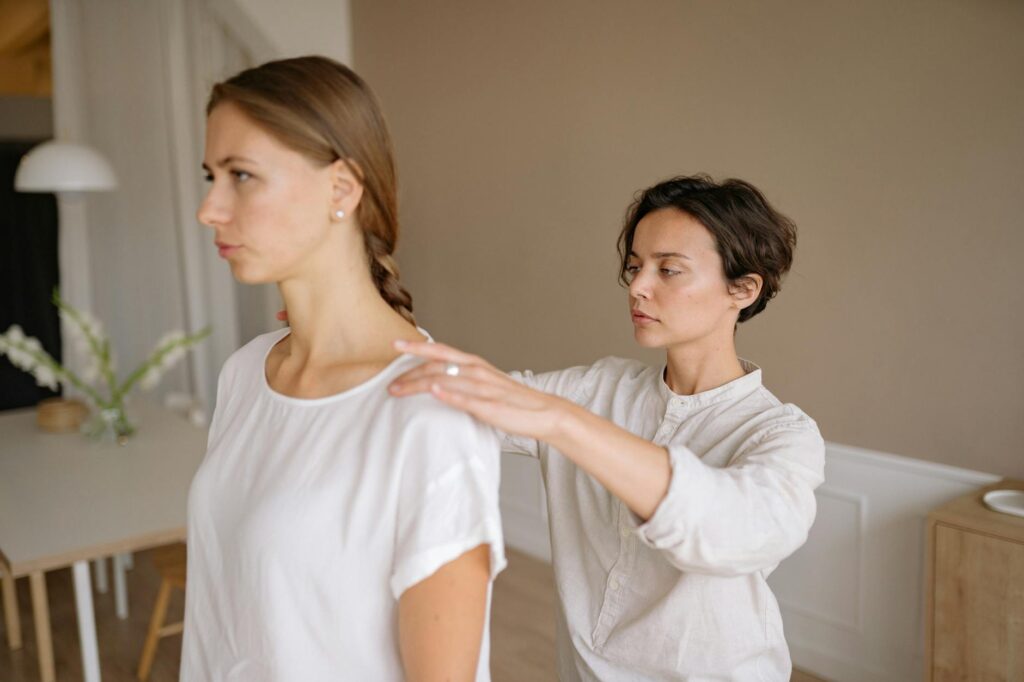 physical therapist working with baseball pitcher
