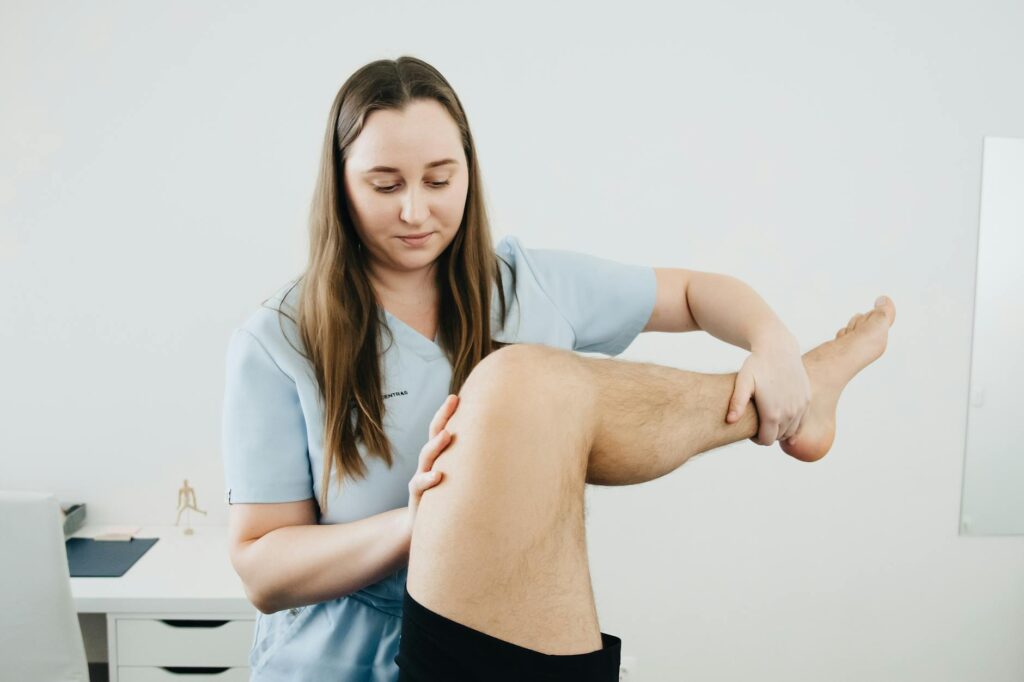 physical therapist working with baseball player