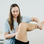 physical therapist working with baseball player