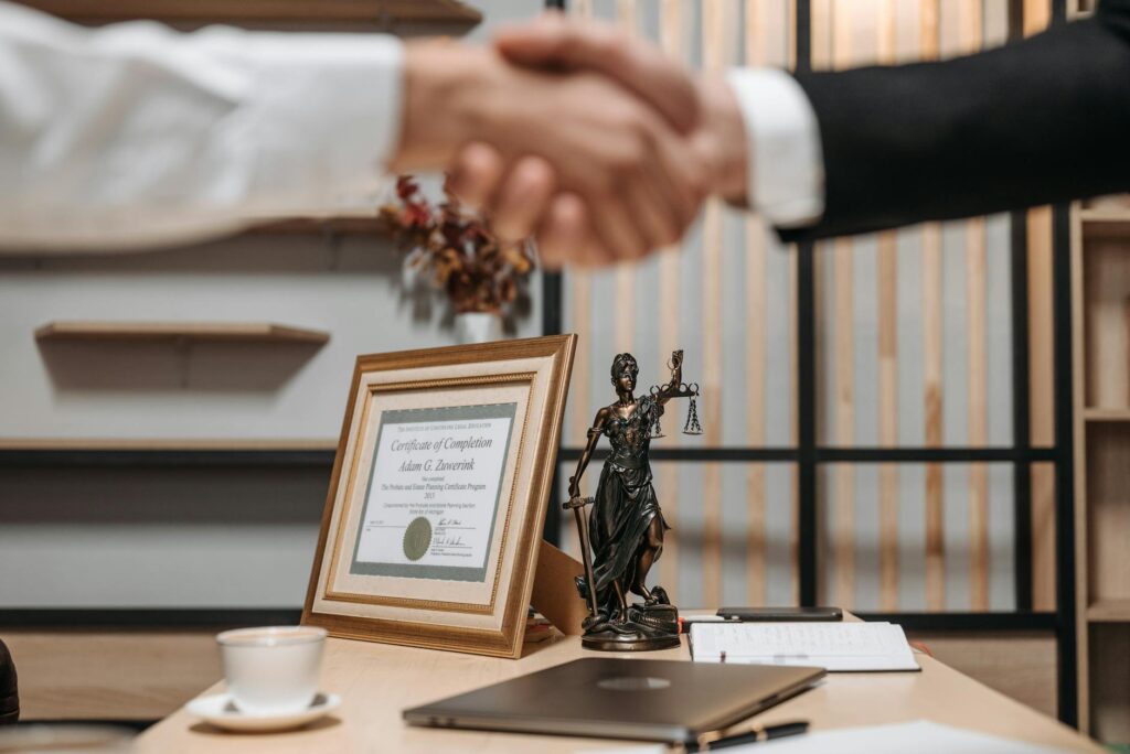 scales of justice and a hand