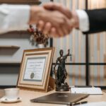 scales of justice and a hand