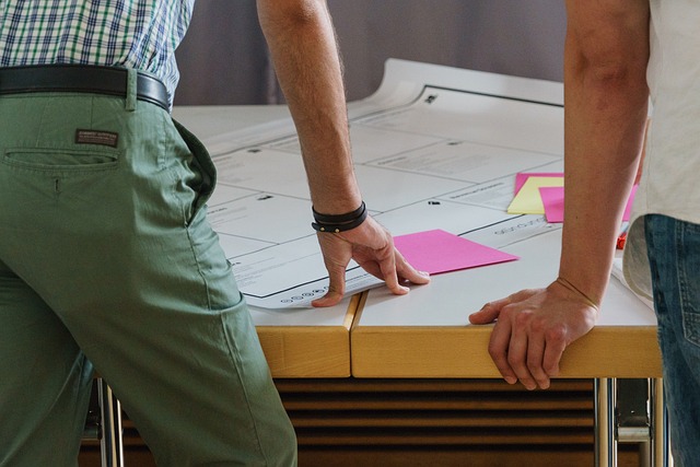 Showrunner brainstorming ideas with sticky notes on a cork board