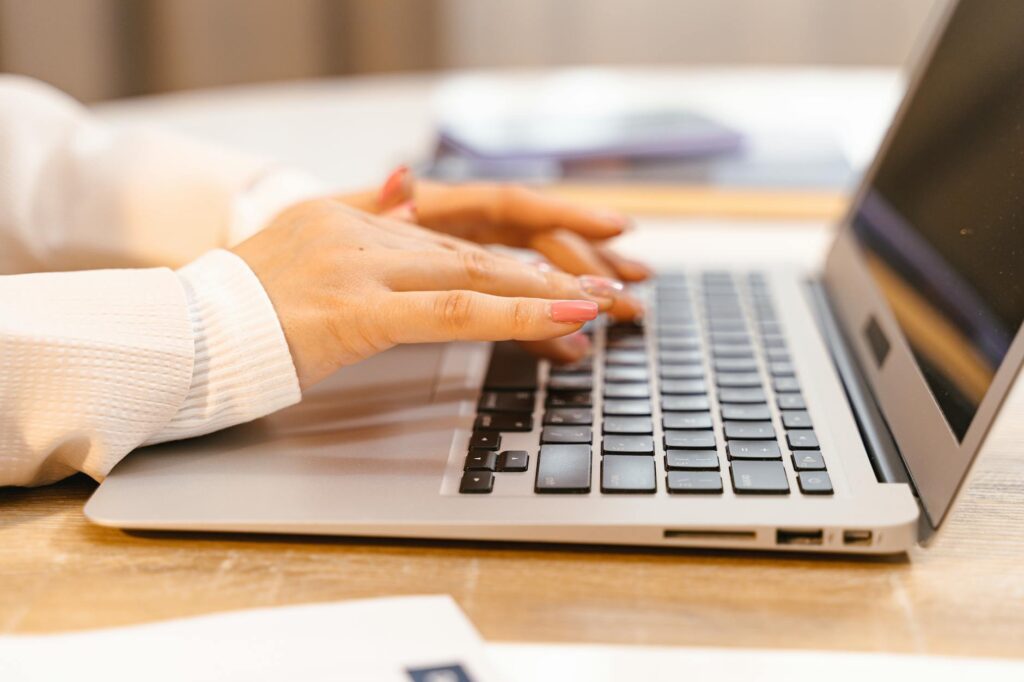 woman writing at laptop lifestyle blog